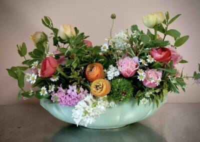 Colorful spring flowers in a green vase.