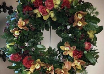 Floral wreath with yellow and red flowers.