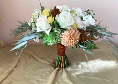 White and yellow roses in a bouquet.