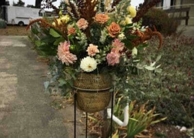 Flower arrangement in a gold planter.