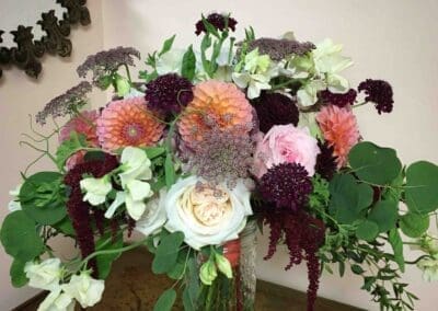 Floral bouquet with pink, white, and purple blooms.