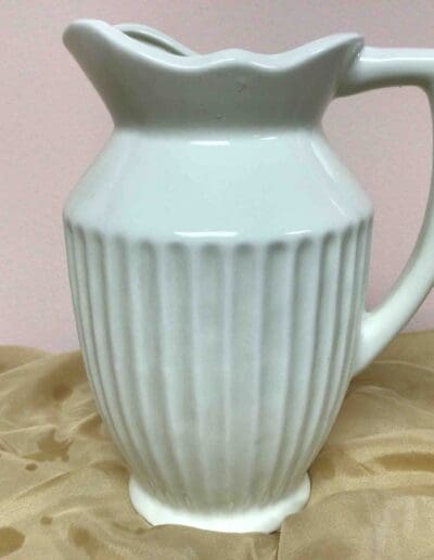 White ceramic pitcher with ribbed design.